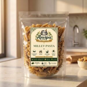 A premium pouch of Anvipa chemical-free Natural Mix Millet Pasta beside a small ceramic bowl showing dry, rustic golden-brown macaroni shapes.