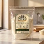 A premium pouch of Anvipa chemical-free Sona Moti Atta alongside a wooden bowl of round golden wheat grains, representing stone milled low GI flour.