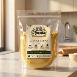 Anvipa pure Chana Besan packaging pouch alongside a pile of unpolished Bengal Gram pulses, representing chemical-free cold stone milled gram flour.