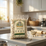 A premium pouch of Anvipa chemical-free Pure Fox Nuts Makhana beside a small bowl of raw, crispy white phool makhana puffs.