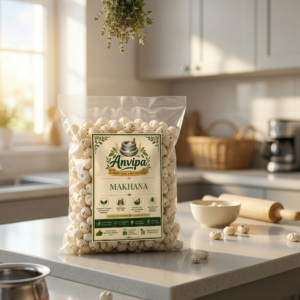 A premium pouch of Anvipa chemical-free Pure Fox Nuts Makhana beside a small bowl of raw, crispy white phool makhana puffs.