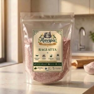 A premium pouch of Anvipa chemical-free Ragi Atta displayed next to raw reddish finger millet grains, showing stone milled gluten-free flour.