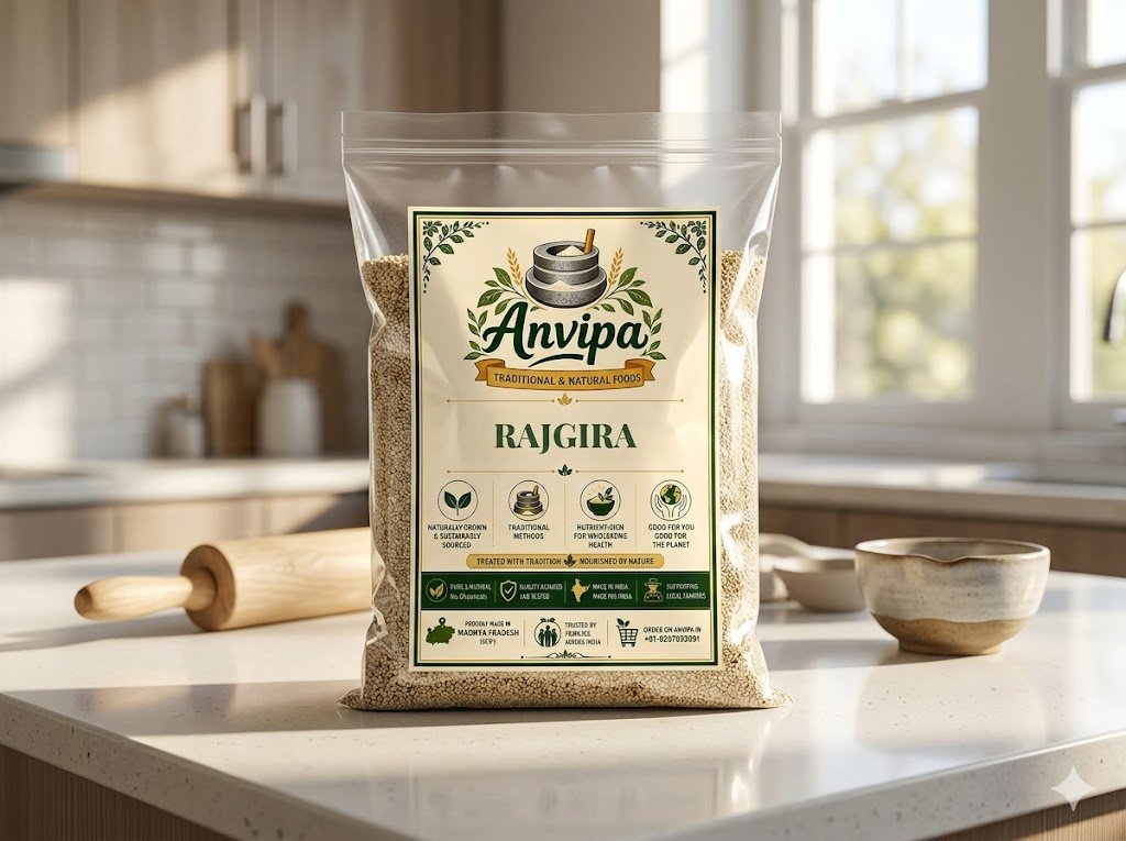 A premium pouch of Anvipa chemical-free Pure Rajgira Seeds beside a small wooden scoop showing clean, raw cream-colored amaranth grains.