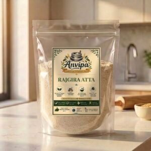 A premium pouch of Anvipa chemical-free Rajgira Atta displayed next to raw amaranth seeds, showing stone milled gluten-free flour.