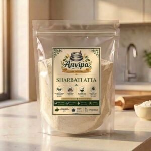 Premium Anvipa Sehore Sharbati Atta whole wheat flour pouch surrounded by golden wheat ears, illustrating natural chemical-free stone milled flour for soft rotis.