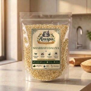 A premium pouch of Anvipa chemical-free Sharbati Daliya next to a rustic bowl of raw broken wheat grains, showing clean natural breakfast porridge.