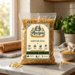 A premium pouch of Anvipa chemical-free Pure Toor Dal beside a small bowl showing clean, raw, and unpolished yellow split pigeon peas.