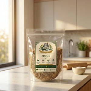 A premium pouch of Anvipa chemical-free Pure Ajwain Seeds beside a small terracotta bowl filled with raw, tiny, and aromatic whole carom seeds.