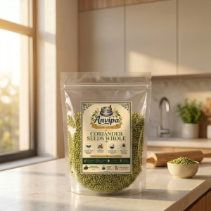 A premium pouch of Anvipa chemical-free Pure Coriander Seeds beside a small terracotta bowl filled with raw, golden-brown whole sabut dhania.