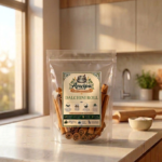 A premium pouch of Anvipa chemical-free Pure Ceylon Cinnamon Rolls beside a small wooden board displaying paper-thin, hand-rolled dalchini quills.