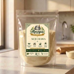 A premium pouch of Anvipa chemical-free Pure Whole Wheat Suji Rawa beside a small ceramic bowl filled with raw, golden-creamy granular wheat semolina.